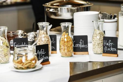 a counter with jars filled with food on a counter top at Haus Maria Lindenberg in Sankt Peter