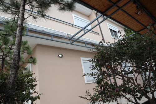 a white house with trees in front of it at Lake Retreat Villa in Shkodër