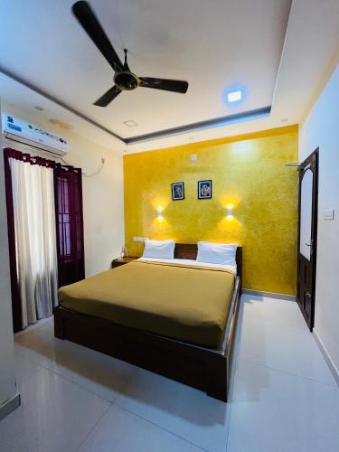 a bedroom with a bed and a ceiling fan at COCHIN HOMES in Cochin