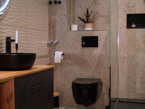 a bathroom with a sink and a glass shower at Living am Carlsplatz Apartment in Düsseldorf
