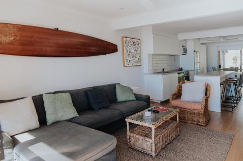 a living room with a couch and a table at Pandanus Palms Holiday Resort in Point Lookout