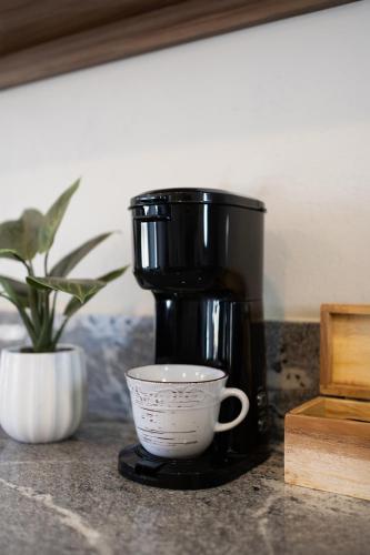 a coffee maker and a cup on a counter at Baja Toscana in Valle de Guadalupe