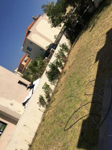 a shadow of a person standing next to a building at Villa tabarka in Tabarka