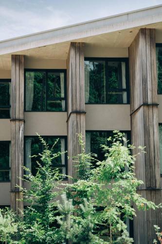 a building with trees in front of it at LOISIUM Wine & Spa Hotel Champagne in Mutigny