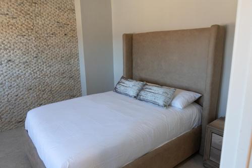a bedroom with a bed with a pillow on it at Baja Toscana in Valle de Guadalupe