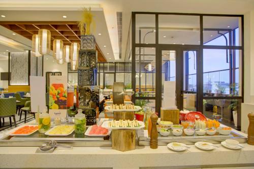 a buffet line with food on display in a restaurant at Cygnett Inn in Dibrugarh