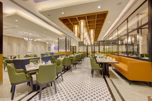a dining room with tables and chairs at Cygnett Inn in Dibrugarh