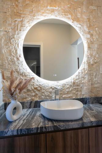 a bathroom with a sink and a mirror at Baja Toscana in Valle de Guadalupe