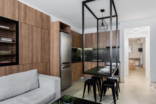 a kitchen and living room with a couch and a table at The Gate by Zoia Living in Athens