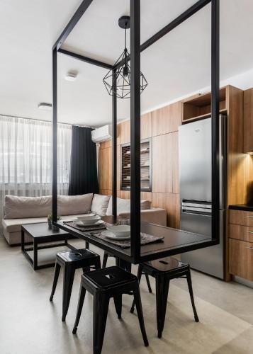 a living room with a dining table and a large mirror at The Gate by Zoia Living in Athens