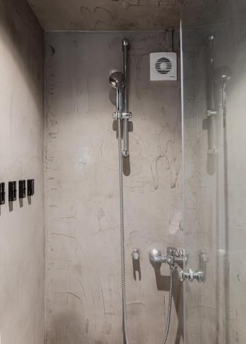 a shower with a glass door in a bathroom at The Gate by Zoia Living in Athens