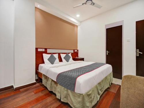 a bedroom with a large bed in a room at Palette - Hotel Saket Greens in Bhopal