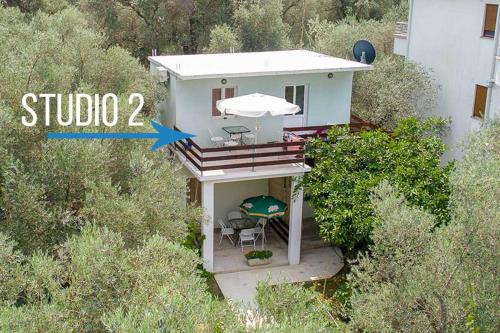 an aerial view of a small house with an umbrella at Apartments Val Maslina in Utjeha
