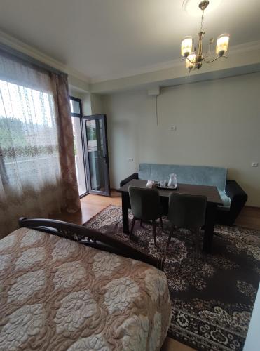 a bedroom with a bed and a table and a couch at MITANE in Sisian