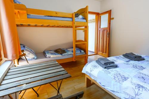 a room with two bunk beds and a bench at rekreační areál Vlaštovčí in Rodowitz