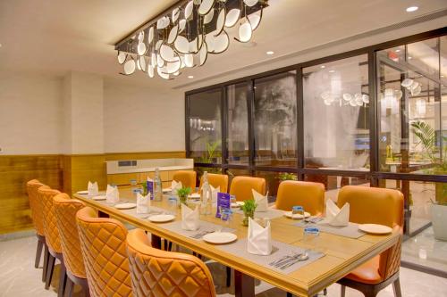 a large dining room with a long table and chairs at Cygnett Inn in Dibrugarh