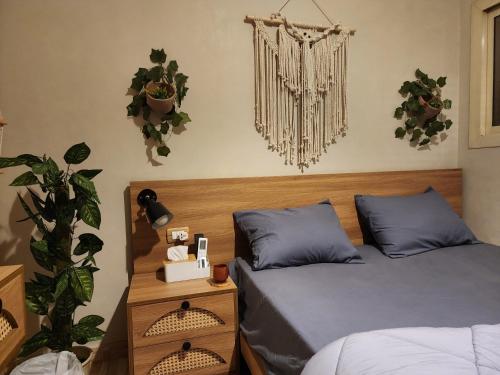 two beds in a bedroom with plants on the wall at Private rooftop with jacuzzi and pyramids view in ‘Ezbet `Abd el-Ḥamîd