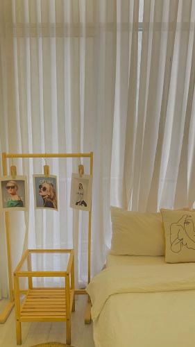 a bedroom with a bed and a table with pictures at The Chill in Hue