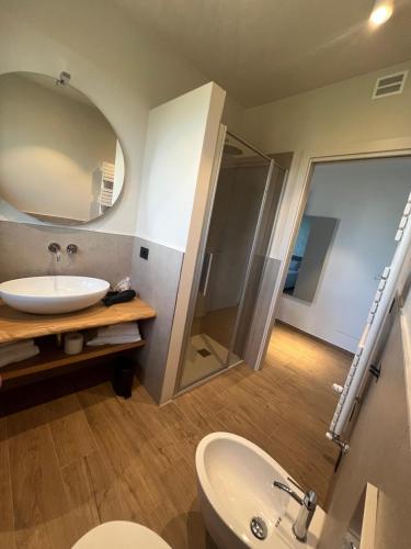 a bathroom with a sink and a mirror at La Porta delle Meraviglie in Saluzzo