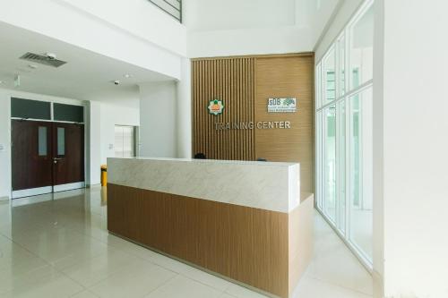 a lobby with a reception desk in a building at Urbanview Hotel Syariah UIN Mataram in Mataram