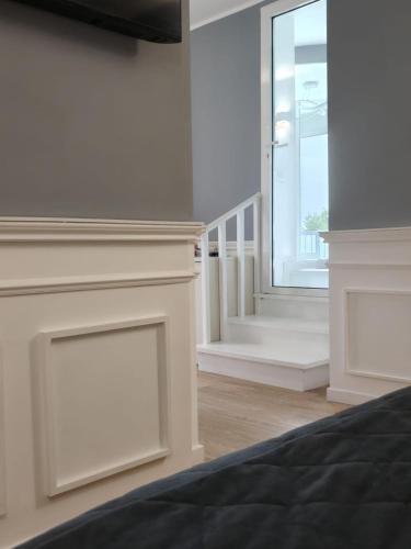a bedroom with a fireplace and a large window at Asso Residence Gold in Terni