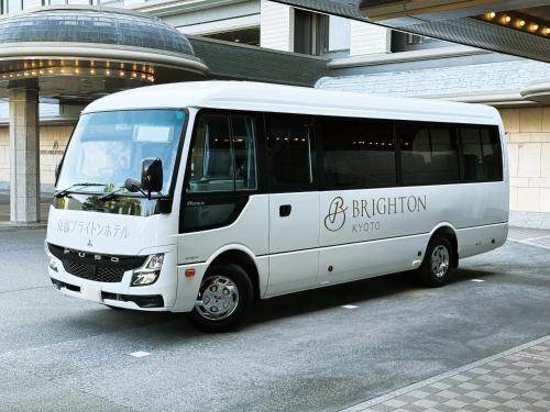 a white bus parked in front of a building at Kyoto Brighton Hotel in Kyoto