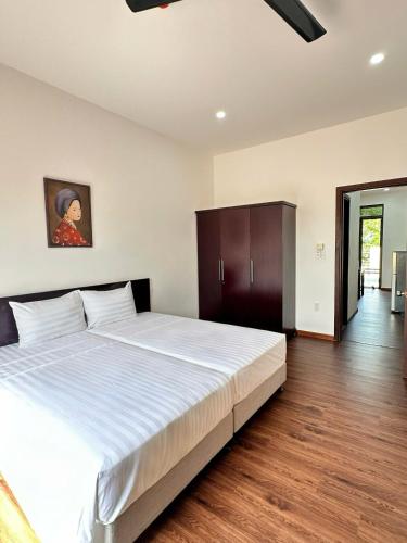 Cama o camas de una habitación en Richico Hoi An Villas