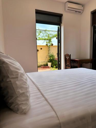 Cama o camas de una habitación en Richico Hoi An Villas