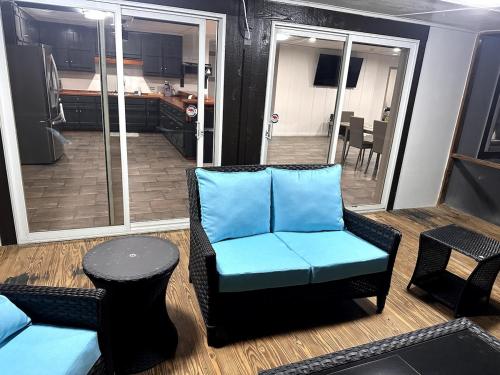a living room with a blue chair and a table at Peaceful Lake House in Newnan