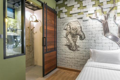 a bedroom with a mural of an elephant on a brick wall at Sea Crest by Jomtien in Jomtien Beach