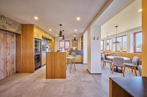 an open kitchen and dining room with a table and chairs at Hotel Bouda Jana in Pec pod Sněžkou