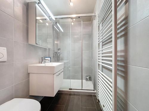 a bathroom with a toilet and a shower at Apartment Méridien 321 in Verbier