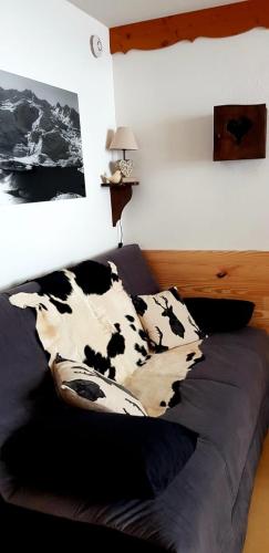 a bedroom with a bed with black and white cows at Balcons B 011 - PARC NAT VANOISE appart 6 pers in Val Cenis
