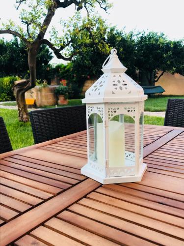 a white lantern sitting on top of a wooden table at Appartamento Relax in Gallipoli