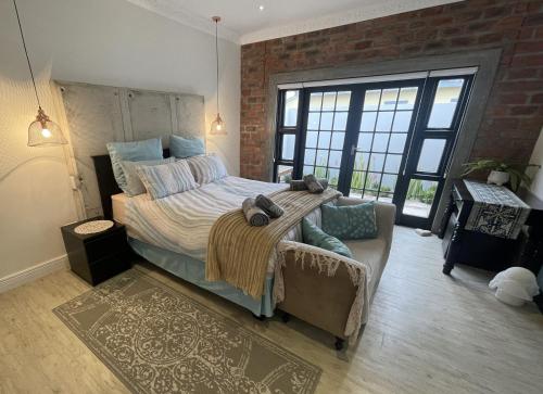 En eller flere senge i et værelse på Olyvenbosch Selfcatering