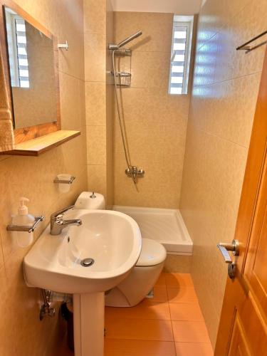 a bathroom with a sink and a toilet and a shower at Roe Sea View in Kyparissia