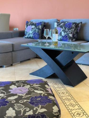 a living room with a table and a couch at Roe Sea View in Kyparissia
