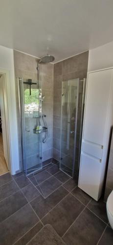 a bathroom with a shower with a glass door at Bungalow Helga in Fürstenwalde