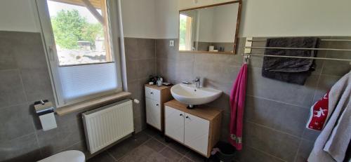 a bathroom with a sink and a mirror at Bungalow Helga in Fürstenwalde