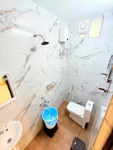 a bathroom with a white marble wall at MG Park in Chennai
