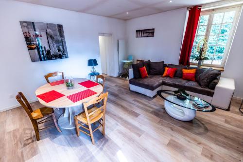 a living room with a couch and a table at La Forge in Cour-Cheverny