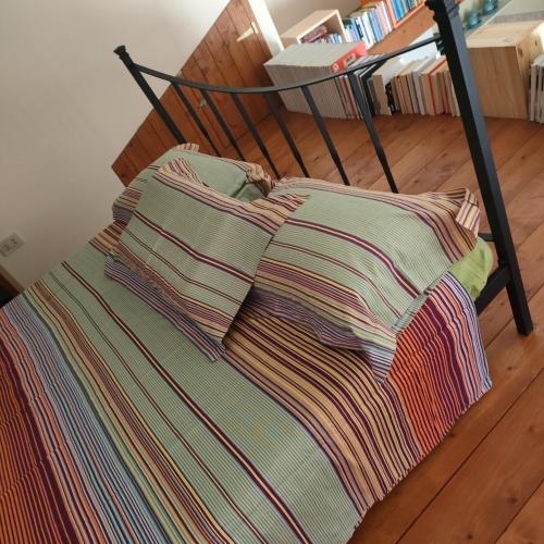 a bed with two pillows on top of it at evvIVA's house in Osimo