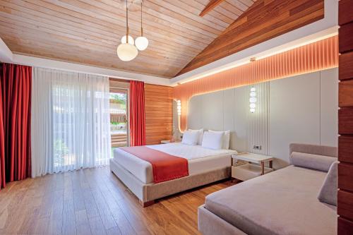 a hotel room with a bed and a couch at Cirali Hera Hotel in Cıralı