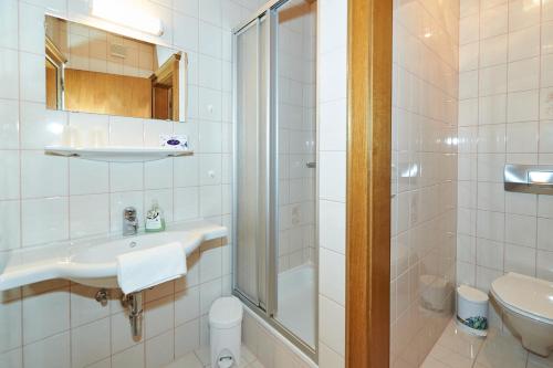 a bathroom with a shower and a sink and a toilet at Haus Gappmaier in Filzmoos