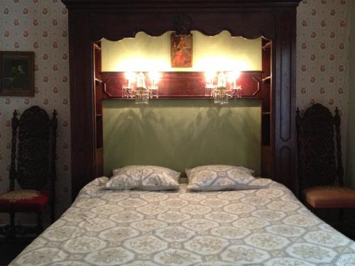 a bedroom with a bed with two pillows on it at Hof ter Wallen in Zoutleeuw