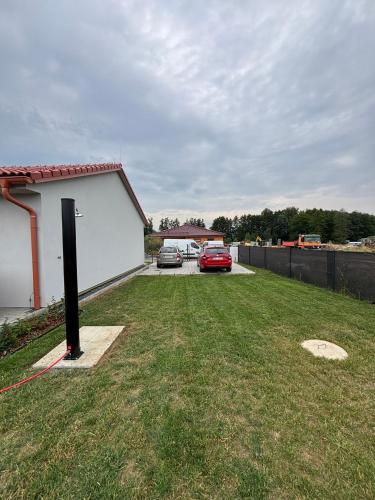 two cars parked in a yard next to a garage at Chalupa Postřekovo in Postřekov
