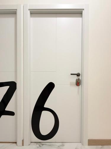 a white door with a letter b on it at Boutique Palacio Centro in Alicante