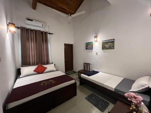a bedroom with two beds and a window at PearlDrop Hills Kandy in Kandy