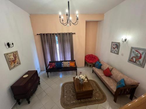 a living room with a couch and a table at PearlDrop Hills Kandy in Kandy