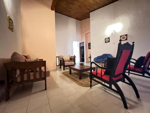 a living room with chairs and a couch at PearlDrop Hills Kandy in Kandy